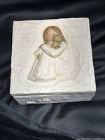 Full view of Willow Tree True trinket box lid showing woman hugging cat relief