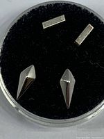 top view of both spear and bar studs in display pad