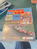 Front cover of 1986 Daytona 500 program showing logo, cars, and publisher