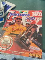 Front cover showing title, driver, logos, trophy