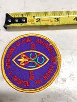 Full view of patch beside measuring tape showing diameter