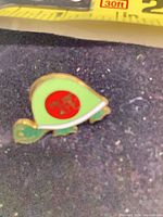 Front view showing avocado-turtle enamel design and colours