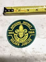 Front view of embroidered Boy Scouts patch with ruler for scale