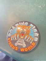 Front view of Circus World Roaring Tiger button showing graphic and text