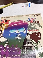 Front cover showing Curtis Mayfield Back to the World artwork