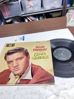 Front cover and vinyl record displayed on table