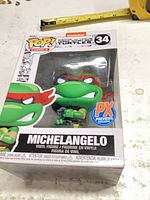 Front view of boxed Michelangelo Pop! showing figure and box details