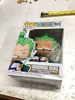 Front angled view of sealed Funko Pop box showing figure and label 923