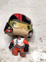 Front view of Funko Pop! pilot showing suit, helmet, detached spring and paint wear