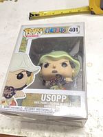 Front view of boxed Usopp Funko Pop in protector