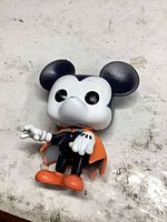 Front view of Funko Pop Mickey Mouse Vampire figure showing costume and paint wear