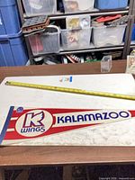 Full view of entire pennant with measuring tape showing length