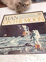 Front cover of Man On The Moon vinyl LP with astronaut image