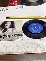 Vinyl single beside printed sleeve on tabletop