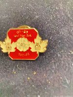 Front view of red and gold enamel 40th anniversary lapel pin