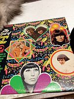Front sleeve artwork with portraits and psychedelic design