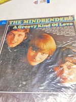 Front of album sleeve under shrink showing title and band image