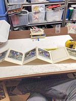 Accordion booklet extended, loose cards visible on table