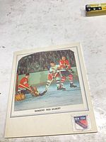 Front of folded booklet showing Rod Gilbert action photo, printed caption and Rangers shield logo