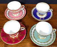 Group view of four teacup and saucer sets showing color variations