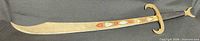 Full view of entire scimitar showing curved blade and hilt