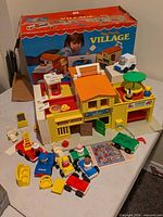 Overall view of playset, box, vehicles, figures and accessories
