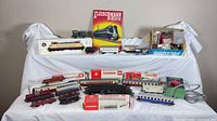 Full lot overview showing locomotives, coaches, freight cars, track, transformer, catalog, boxes