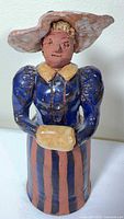 Front view of ceramic figurine showing costume details