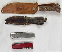 all four knives/multi-tools with both sheaths displayed front side