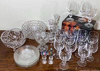 Entire lot showing bowl, compote, candlesticks, plates, wine glasses, shakers