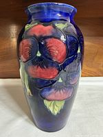 Front view showing pansy decoration and cobalt glaze