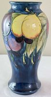 Front view of Moorcroft Wisteria vase showing blue ground and multicolour decoration