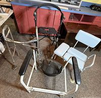 Group shot showing rollator, folding walker, shower chair frame and transfer bench