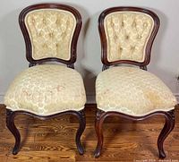 Front view of both chairs showing upholstery, frames and general wear