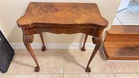 Full view of table front showing serpentine top and leg design