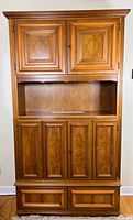 Full front view closed upper doors, open shelf, closed lower doors and drawers