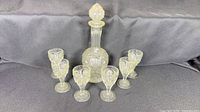 decanter with stopper and six glasses displayed
