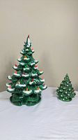 Both ceramic Christmas trees side by side showing size difference and cords