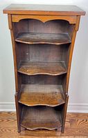 front view showing four shelves and finish wear