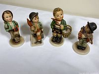 Front view of all four figurines lined up