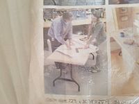 Photo of a person unfolding and using the multi-use table, showing its size and leg structure.