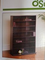 Front view of the multimedia storage tower showing six shelves and cinnamon cherry finish.