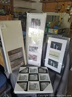 Three brand new multi picture frames: black frame with nine photo slots, white frame with three slots, and black frame with three slots, all for 4x6 inch photos.