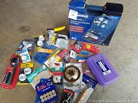 Photo showing Mastercraft heat gun kit in blue box, assorted new tools and hardware items spread out on floor