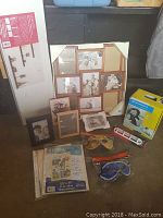 Overview of picture frames, wireless headphones, scrapbook sheets, masks, and wall shelf box