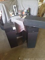 Yamaha speakers large and small with cassette tapes, microphone, pens on a table