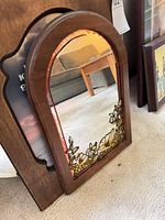Arched wood mirror with stained glass floral detail