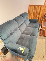 Front angle of blue/teal reclining sofa