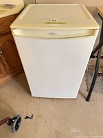 Front view of white Danby compact refrigerator