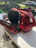 Open red Honda top case lid showing interior and gas strut